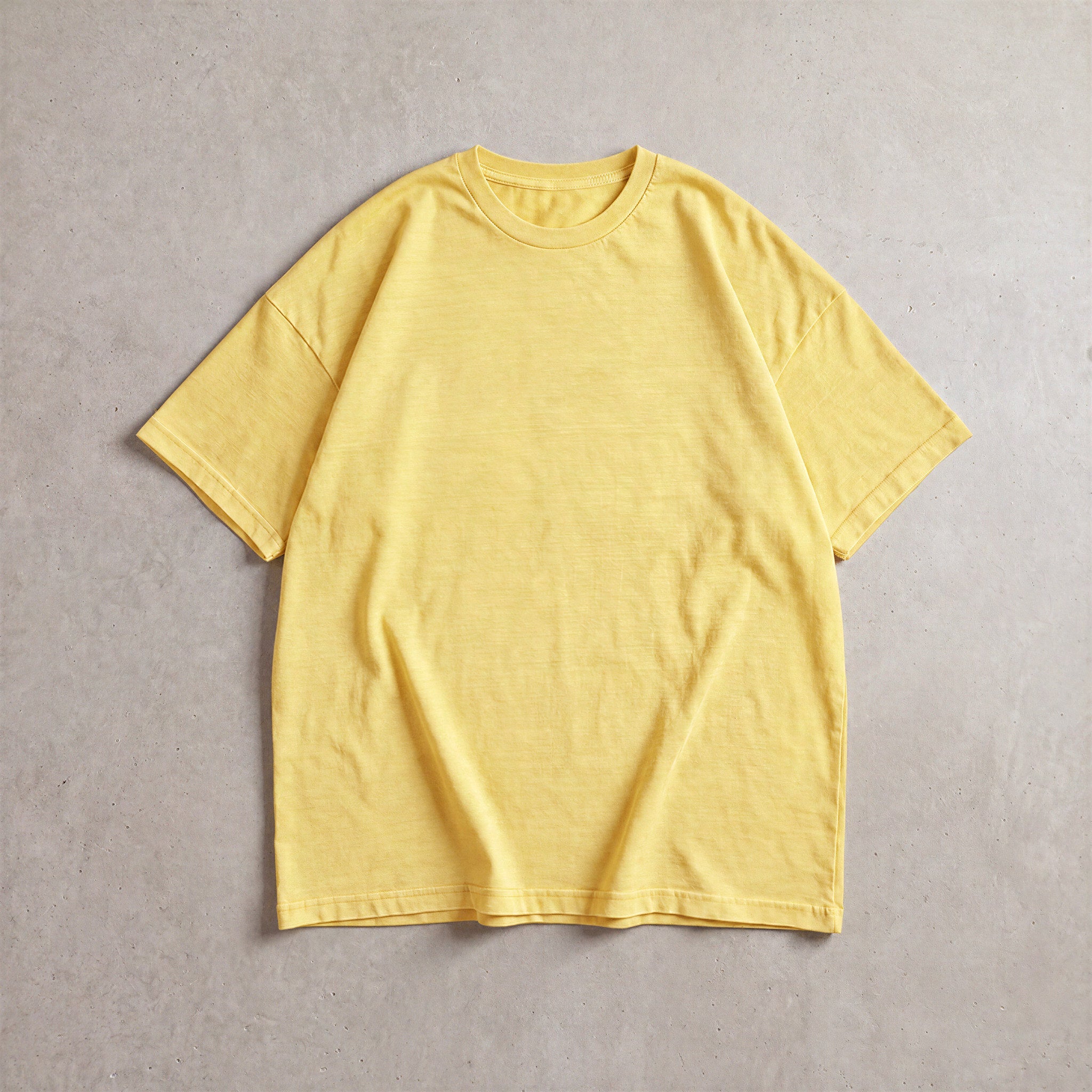Cotton Collective Vintage Butter 6.0 oz Tour S/S Tee, styled flat lay