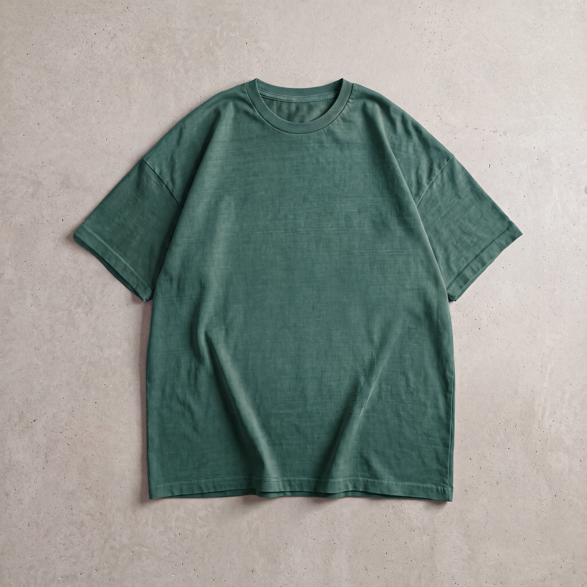 Cotton Collective Vintage Spruce Green 6.0 oz Tour S/S Tee, styled flat lay