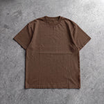 Cotton Collective Chocolate Daily S/S Tee 6.5oz, laid flat on concrete