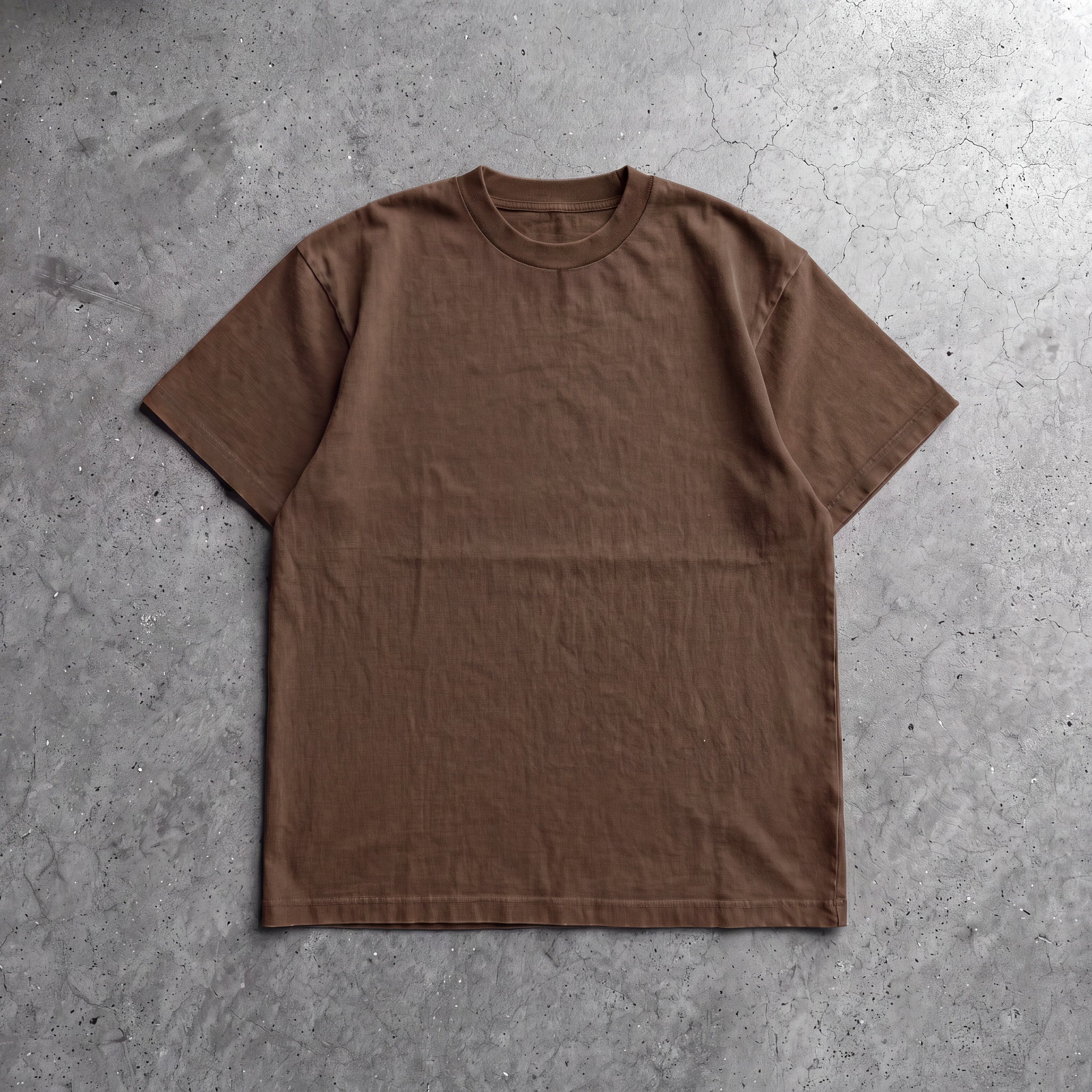 Cotton Collective Chocolate Daily S/S Tee 6.5oz, laid flat on concrete