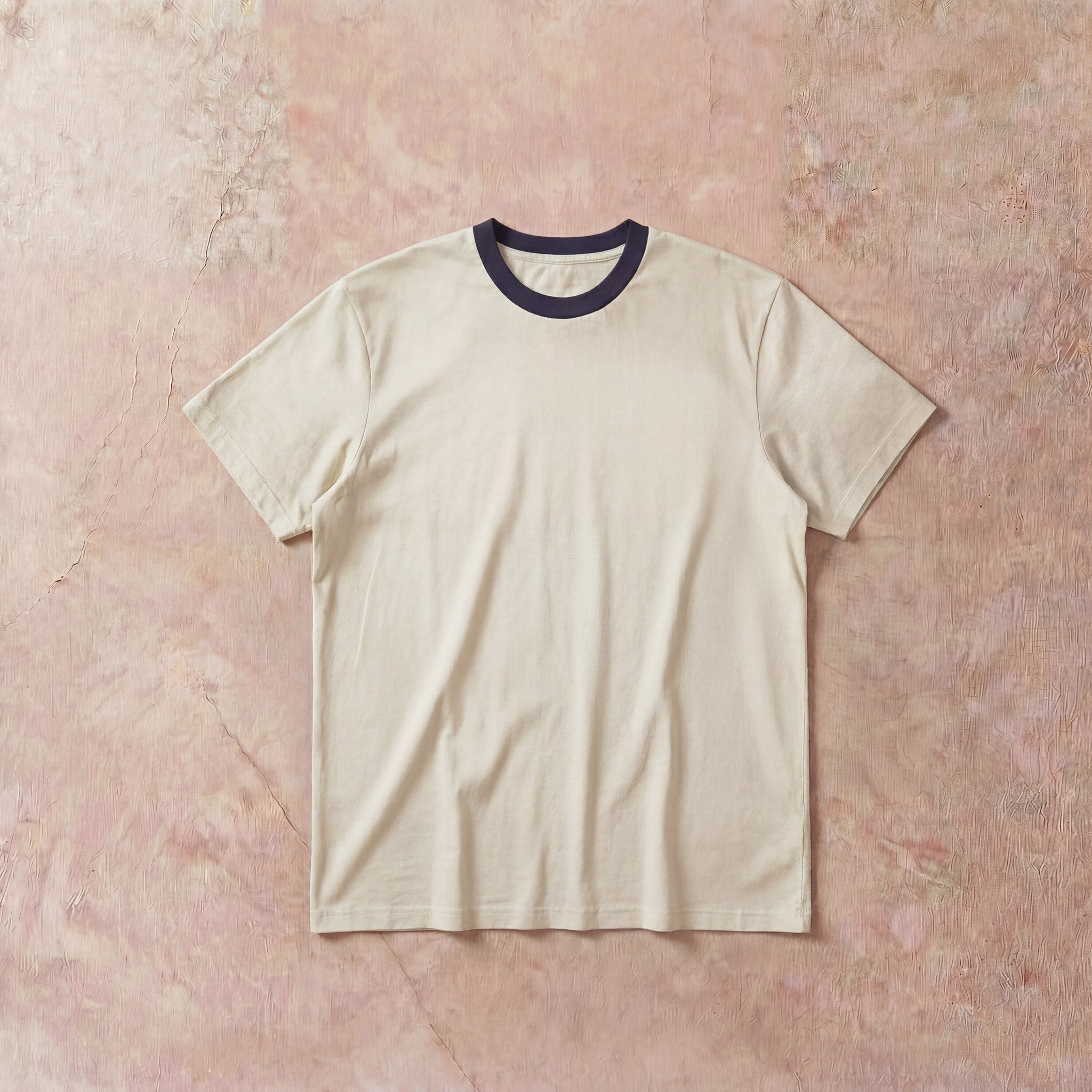 Cotton Collective Ringer Cream Navy Oversized Box S/S Tee 7.5oz, laid flat on concrete