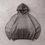Cotton Collective Charcoal Oil Wash Special Hoodie 14oz, laid flat on concrete
