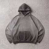 Cotton Collective Charcoal Oil Wash Special Hoodie 14oz, laid flat on concrete
