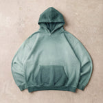 Cotton Collective Jasper Oil Wash Special Hoodie 14oz, laid flat on concrete