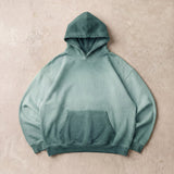 Cotton Collective Jasper Oil Wash Special Hoodie 14oz, laid flat on concrete