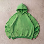 Cotton Collective Verde Green Special Hoodie 14oz, laid flat on concrete