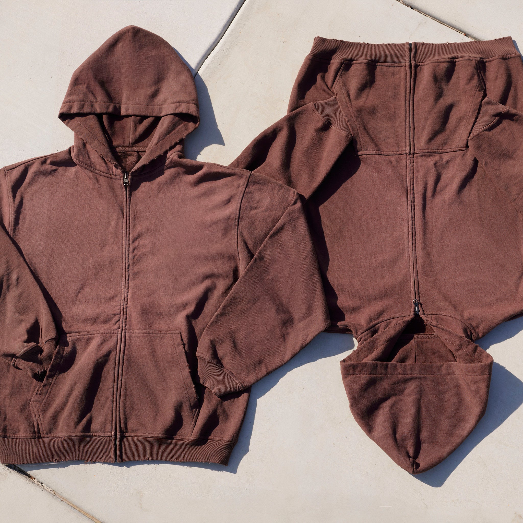 Cotton Collective Potassium Choc Special Zip Hoodie 14oz, set laid flat on concrete