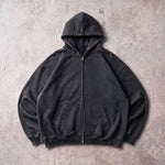 Cotton Collective Vintage Black Special Zip Hoodie 14oz, laid flat on concrete