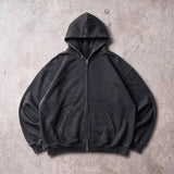 Cotton Collective Vintage Black Special Zip Hoodie 14oz, laid flat on concrete