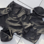 Cotton Collective Vintage Black Standard Hoodie 11oz, laid flat on concrete