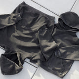 Cotton Collective Vintage Black Standard Hoodie 11oz, laid flat on concrete